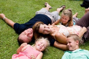 Happy Family lying on grass on holiday